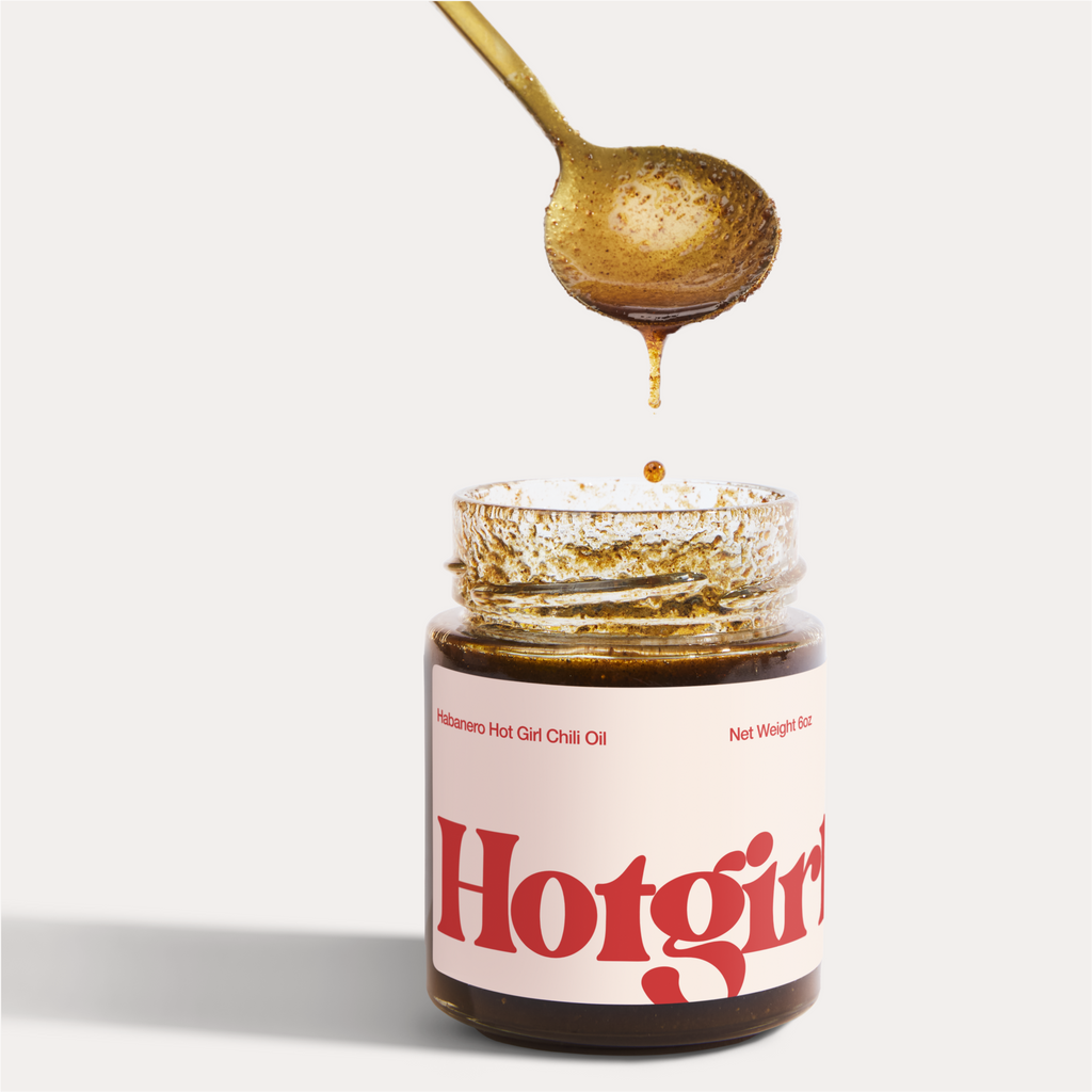 Spoon dripping in Hotgirlsauce habanero chili oil jar